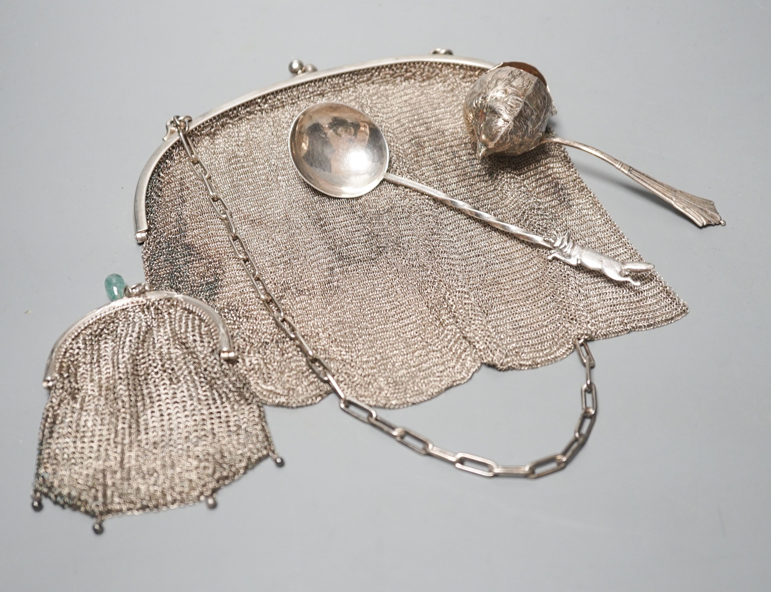A George silver Arts & Crafts spoon, by Albert Edward Jones, two white metal mesh evening bags and a silver sparrow pourer spoon.
